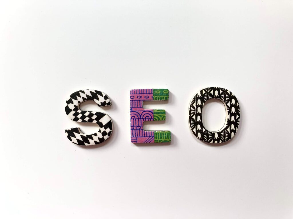 The letters 'SEO', each in a different colourful pattern, on a white background