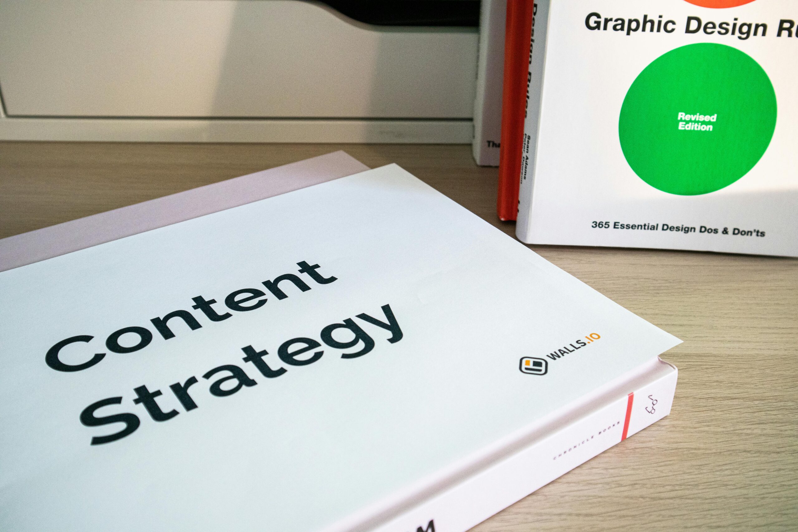 A white box on a wooden desk with the words 'Content Strategy' printed on the cover of it.